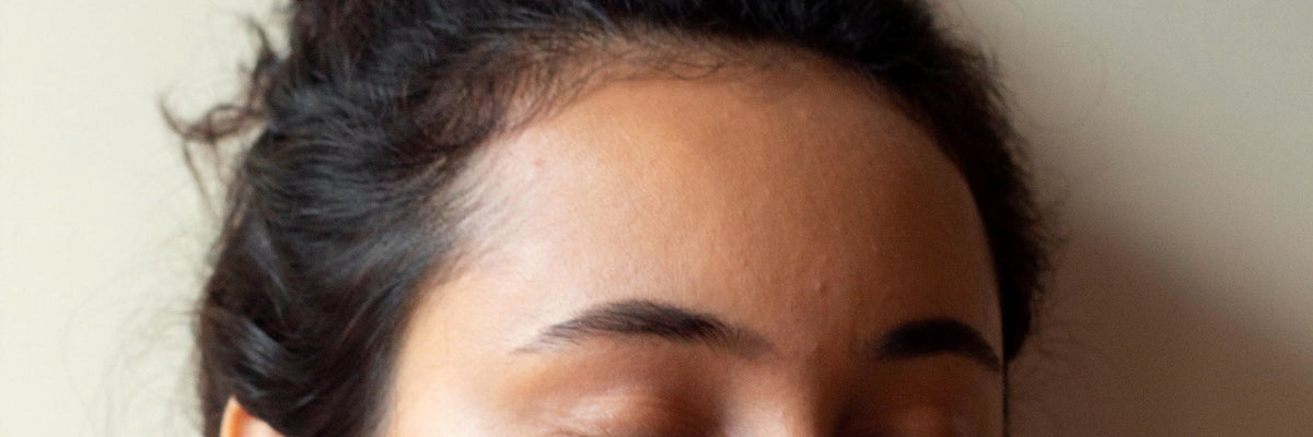 Woman with closed eyes resting her cheek in her hand