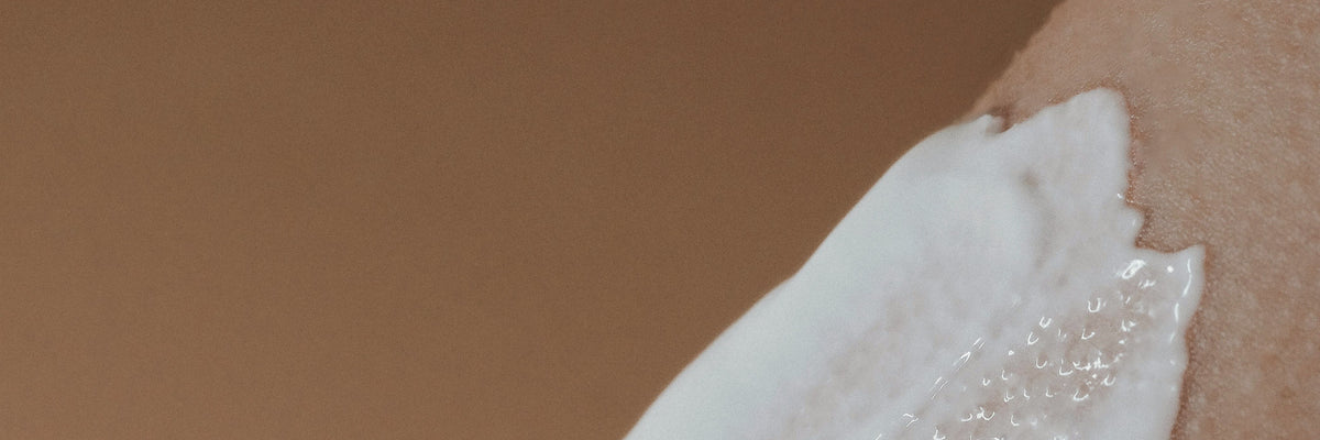 Face cream texture swatch on warm skin