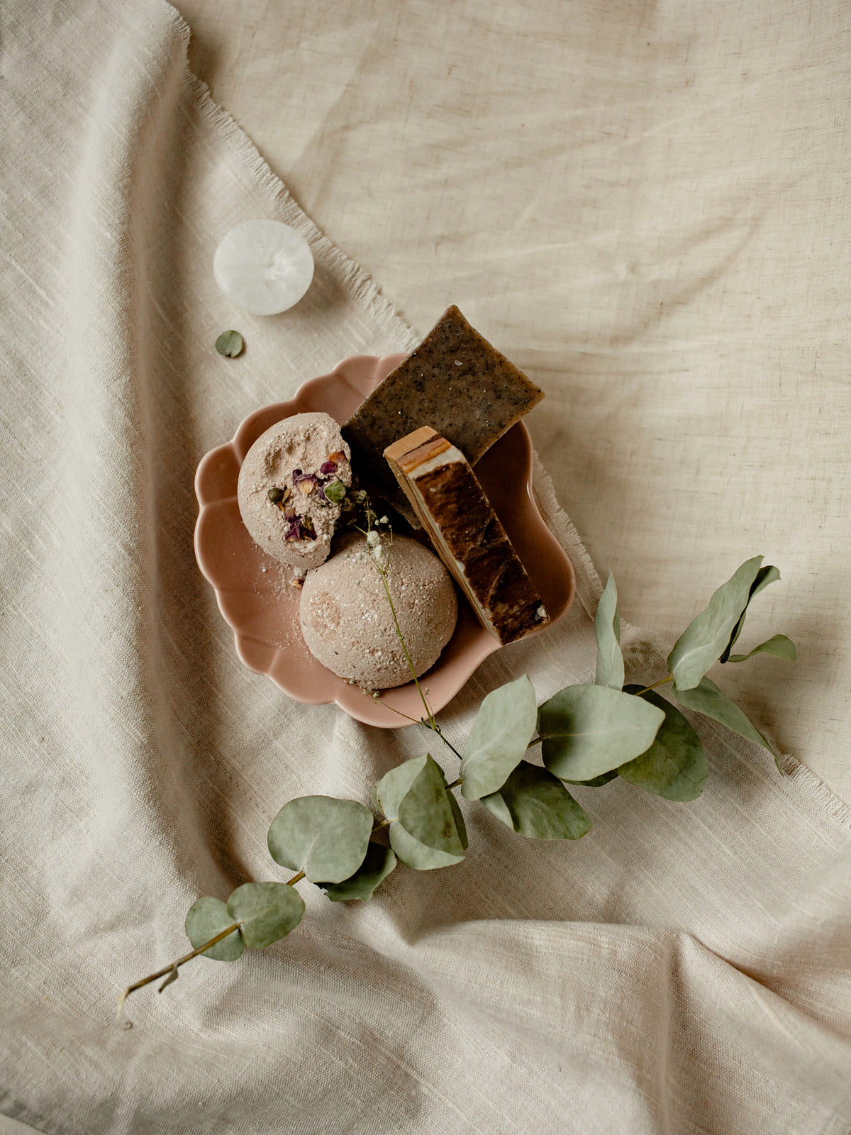 Skincare flat lay with eucalyptus on linen